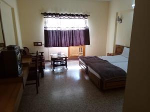 een hotelkamer met een bed en een raam bij Hotel Lakeview in Bhuj