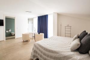 a bedroom with a bed and a table and chairs at Villa Coppitella, rooms & apartments in Vieste +92 photos
