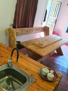 a kitchen counter with a sink and a wooden table at Panorama guesthouse Mata C. in Adishi