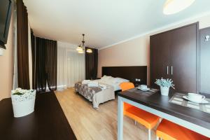 a hotel room with a bed and a dining table at Apartments Prestige Petrcane 1 in Petrcane +88 photos