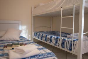 two bunk beds in a room with towels at Elysium in Glinádhon