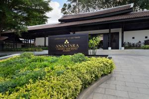 a sign in front of a building with some bushes at Anantara Lawana Koh Samui Resort in Chaweng