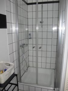 a shower with a glass door in a bathroom at Rossis Haus in Schneverdingen +11 photos