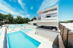 an image of a house with a swimming pool at Apartments Prestige Petrcane 1 in Petrcane
