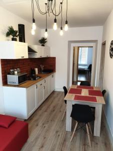 a kitchen and dining room with a table and chairs at Kobi in Kielce