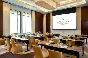 a restaurant with tables and chairs and a projection screen at Anantara Lawana Koh Samui Resort in Chaweng