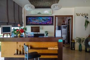 a bar with a desk with a computer in a room at Na Vela Village - Adults Only Hotel in Ko Lanta