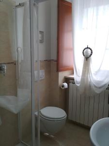 een badkamer met een toilet en een glazen douche bij B&B Monticelli in Gubbio