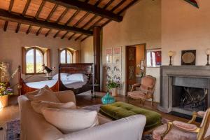 a living room with a bed and a fireplace at Castello Di Vicarello in Sasso dʼOmbrone