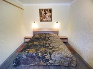 a bedroom with a large bed in a room at Lux Apartment on Mayakovsky 6 in Ustʼ-Kamenogorsk