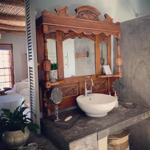 a bathroom with a sink and a mirror at The Oystercatchers Haven at Paternoster in Paternoster