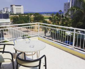 a patio with a table and chairs on a balcony at Hotel Villa Granada in Antalya