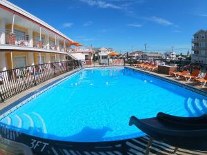a large blue swimming pool in front of a building at Sea Chest Motel Dot Com for Deals! in Wildwood Crest