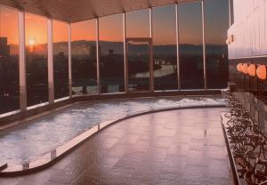 a swimming pool on the top of a building at Hotel Riverge Akebono in Fukui
