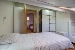 a bedroom with a large white bed and a door at Bairro Alegre, Casa do Porto in Porto