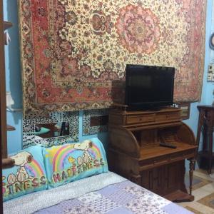 um quarto com uma cama, uma televisão e um tapete em King's Home Hua Hin Homestay em Hua Hin