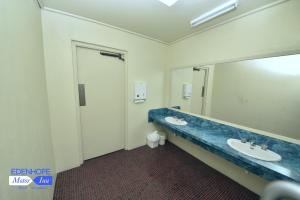 a bathroom with a sink and a mirror at Edenhope Motor Inn in Edenhope +17 photos