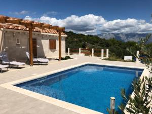 a swimming pool in front of a villa at Villa Ancora in Selca