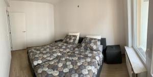 een slaapkamer met een bed met een dekbed bij Vitamine Zee in Oostende