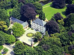 an aerial view of a large house in the trees at Hotel Kasteel Solhof in Aartselaar