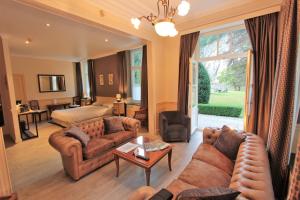 a living room with a couch and a bed at Chateau Cardinal in Durbuy