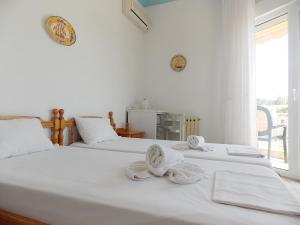 Postel nebo postele na pokoji v ubytování Hotel Sgouridis