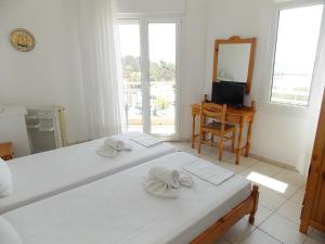 Postel nebo postele na pokoji v ubytování Hotel Sgouridis