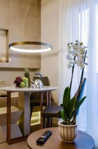 a dining room with a table and a potted plant at L - Suites in Kavála