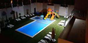 an overhead view of a swimming pool with a playground at Hotel Pacha in Oran