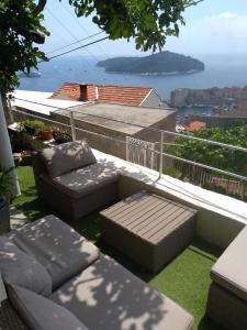 a balcony with two couches and a view of the ocean at Apartment Teo in Dubrovnik