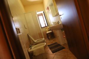 a small bathroom with a toilet and a sink at Casale dell'Arvo in Lorica +49 photos