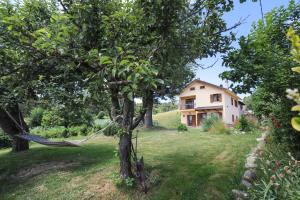a hammock tied to a tree in front of a house at Casale dell'Arvo in Lorica