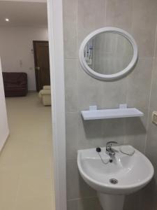 a bathroom with a white sink and a mirror at S+1 vue mer climatisé in Chott Meriem