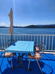 a table and chairs on the deck of a cruise ship at Apartments Jerkovic in Klek