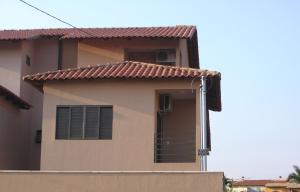 a house with a fence in front of it at Pousada Jaó in Goiânia