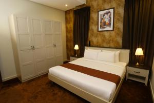 a bedroom with a large bed and two night stands at Grand Dahlia Hotel Apartment - Sabah Al Salem in Kuwait +49 photos