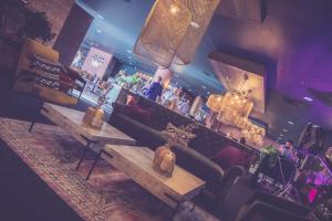 a bar with a couch and a table in a room at Waterfront Southport Hotel in Southport
