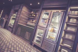 a kitchen with an open refrigerator with dishes at Waterfront Southport Hotel in Southport