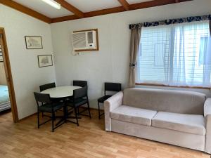a living room with a couch and a table at Tatura Cabin & Caravan Park in Tatura