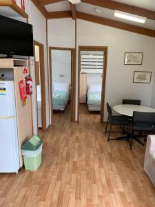 a room with a room with a table and a bed at Tatura Cabin & Caravan Park in Tatura