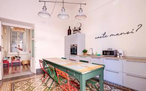 a kitchen with a green table in a room at Costello in La Spezia