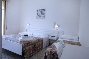 Postel nebo postele na pokoji v ubytování Hotel Lagomaggio + 17 fotografií