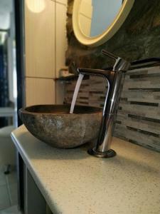 a sink with a faucet in a bathroom at Anatoli Studios in Skhoinoussa