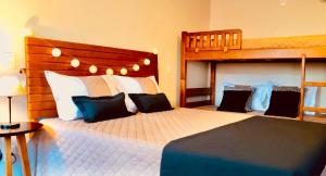a bedroom with two beds and a bunk bed at STUDIOS 195 - Gramado in Gramado