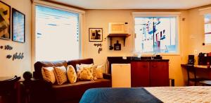 a living room with a couch and a window at STUDIOS 195 - Gramado in Gramado