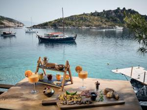 
a boat sitting on top of a dock next to a body of water at Nobelos Seaside Lodge in Agios Nikolaos

