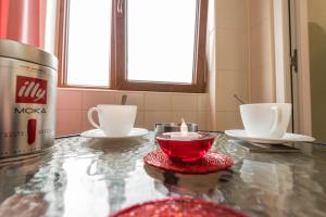 a table with a candle and two cups on it at Ambiance studio in Galaţi +5 photos