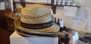 a straw hat sitting on top of a table at La Casa Vecchia in Valdobbiadene