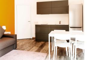 a kitchen with a white table and white chairs at Ariston Appartment in Bolzano