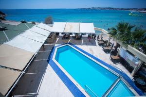 una vista aérea de una piscina y el océano en Tuntas Beach Hotel - All Inclusive, en Didim